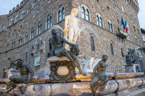 Commercial sign in the background of the Fountain of Neptune of Florence at Piazza della Signora. It was created by Bartolomeo Ammannati between 1560-1574.