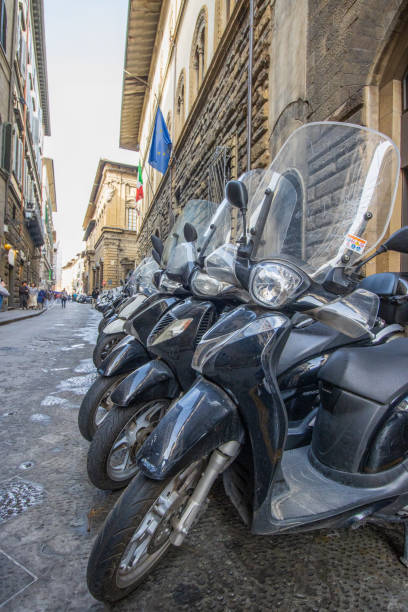 Motorcycles at Florence in Tuscany, Italy, with people in the background.