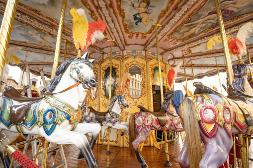 Carousel Horses on Piazza della Repubblica in Florence at Tuscany, Italy. Copyrighted patterns are visible on the horses.