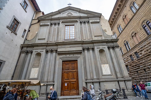 San Giovannino degli Scolopi on Via de'Martelli at Florence in Tuscany, Italy, with people outside.  In 1775 this church passed to the Scolopian fathers, known as the Order of the Scuole Pie