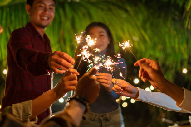 istock young party people holding sparkler in celebration 1452836509