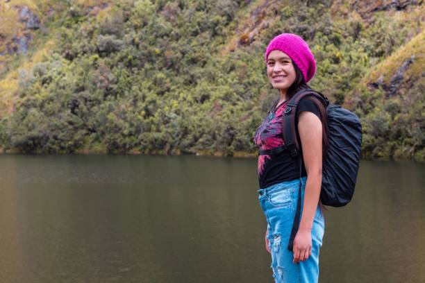 istock Attractive hiker standing next to a tranquil lake in the beautiful mountains 1452837052