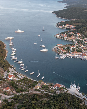 Fiskardo, Greece – August 01, 2021: An aerial shot of the coastline with resorts by the boats in the in Fiskardo, Greece