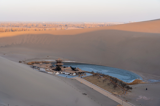 An aerial view of crescent lake Yueyaquan in desert