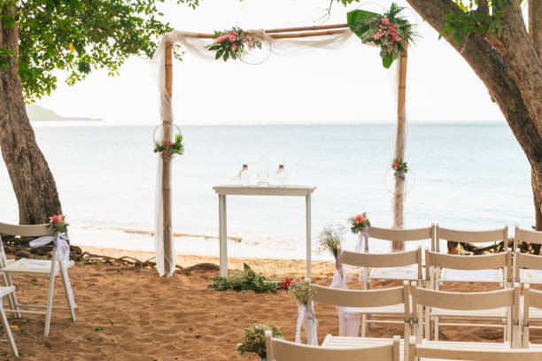 istock Simple beach wedding set up beside a tree on the seaside 1452838483