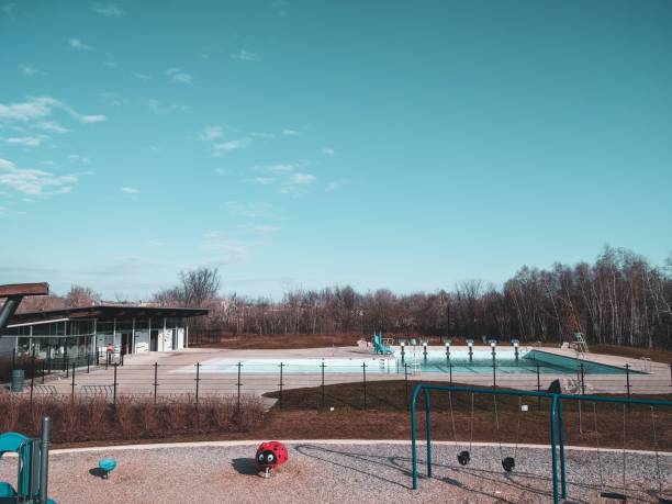 istock Empty childrens' playground and a pool under the blue sky 1452839433