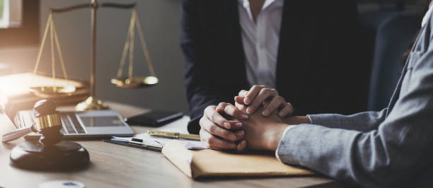 istock Justice and attorney concept. Lawyer meeting and consoling solution to his client provide legal advice and trust commitment strain serious for problem 1452842055