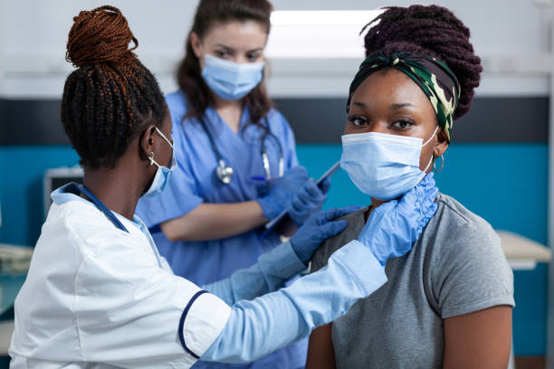 istock African american doctor mesauring cardiac pulse while 1452842208