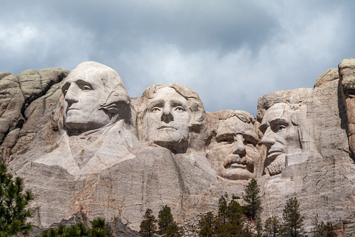 Close up view of Mount Rushmore under a blue sky