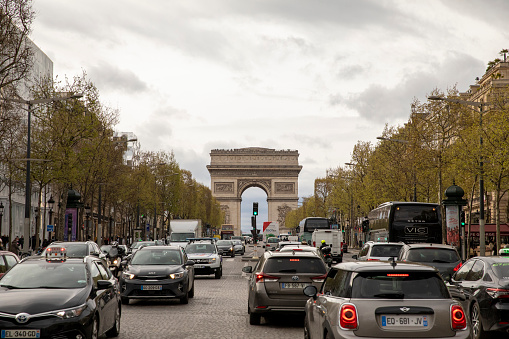Paris, France – April 24, 2022: A scenic view of the Triumphal Arch of the Star in Paris, France in cloudy sky background