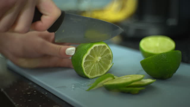 Female cutting lime on board