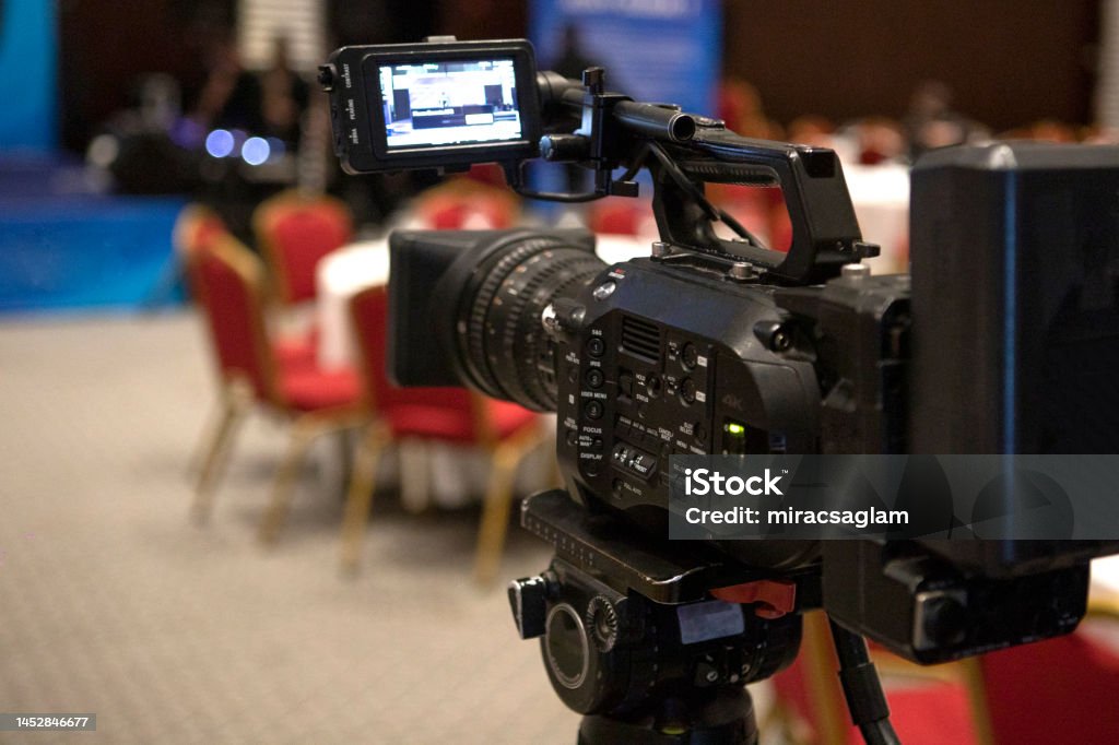 Video camera taking live video streaming with people working background at meeting room. Selective focus. stock photo. Broadcasting Stock Photo