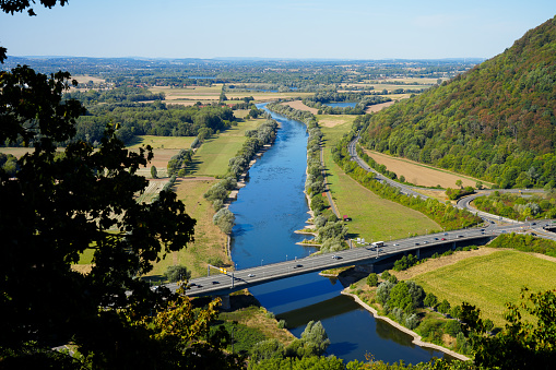 View of the landscape and the Weser from the Porta-Kanzel in Porta Westfalica. Green nature with a river, fields and hills.