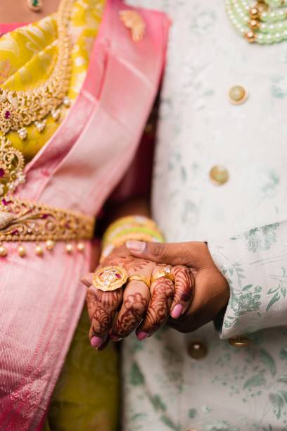 istock Indian bride and groom holding hands 1452848228