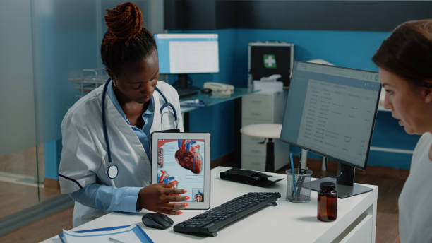 istock African american doctor showing cardiovasular image on tablet 1452848597