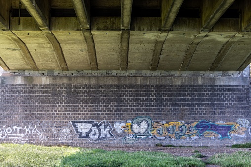 Roermond, Netherlands – April 15, 2022: Colorful graffiti under The Louis Raemaekersbrug bridge otherwise called the Maasbrug in Roermond, Netherlands