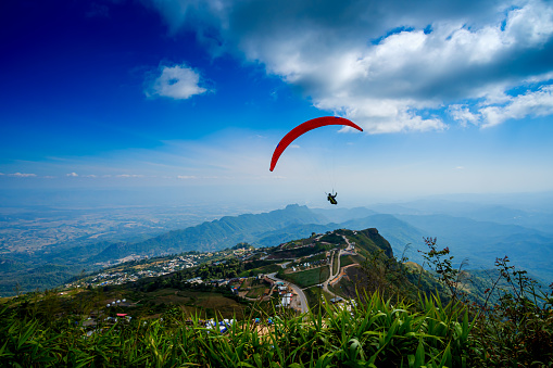 Paragliding concept, paraglider pilot fly in sky on beauty nature mountain landscape,Phu Thap Boek,Khao Kho,Phetchabun, Thailand
