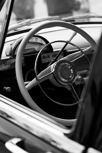 Bad Bentheim, Germany – May 17, 2022: An oldtimer black car steering wheel