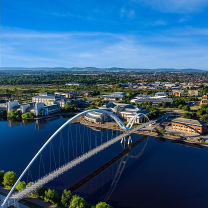 Aerial view of the Infinity Bridge spanning the river Tees located in Stockton on tees, North East England with the Cleveland Hills in the background