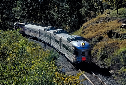 Branson, United States – September 29, 2001: The Branson Scenic Railway rolls through the hills sporting early autumn colors giving passengers a spectacular view from the doomed observation cars.
