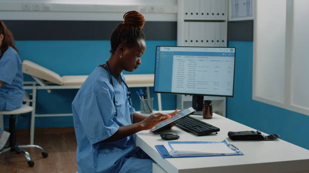 istock African american nurse using digital tablet for treatment 1452851903