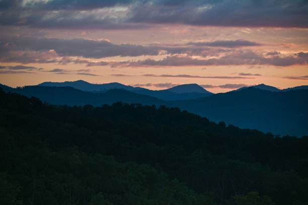 istock Cloudy sunset sky over the forested hills in spring in the evening 1452853443