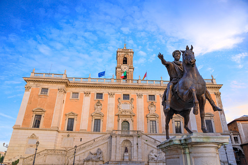 Michelangelo Buonarroti built an podium for Marcus Aurelius’ equestrian statue and placed it in the centre of the hill in 1537.\nMichelangelo also designed an imposing wide step staircase culminating in the solemn balustrade for Palazzo Senatorio, surmounted by classical marble groups.