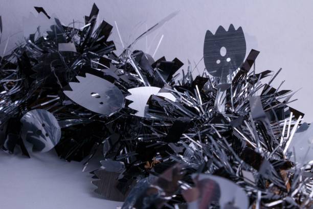 istock Scary tinsel wreath in silver and black with shrieking ghosts. Fun Halloween background 1452853710