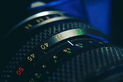 A black camera lens on a blurred background