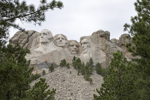 Mount Rushmore National Memorial highlighted by the sculpture of four American presidents carved into the mountainside located in the Black Hills of Pennington County, South Dakota.