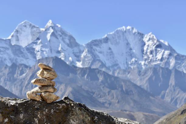 istock Stack of rocks with a mountain range in the background - a cairn 1452854578