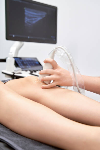 istock Doctor doing an ultrasound scan while examining a patient's knee. 1452856321