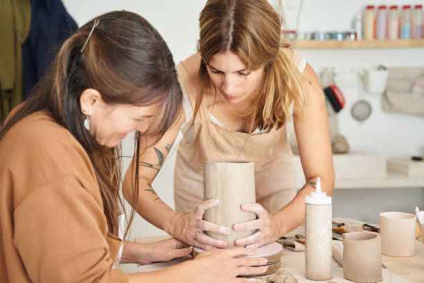 istock Two women working with clay in a pottery workshop. 1452858601
