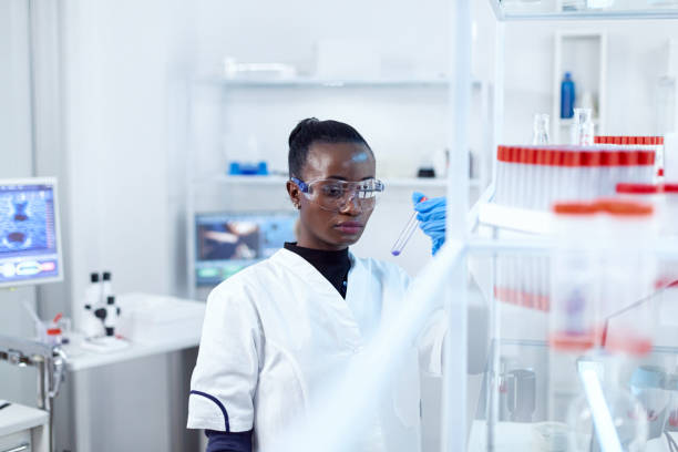 istock African scientist holding test tube with blue liquid 1452860781