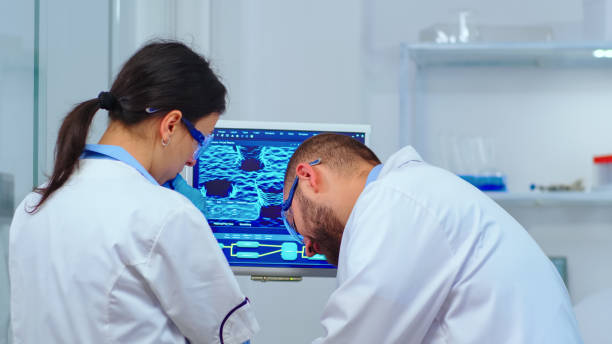 istock Team of scientists discussing about virus development in front of pc 1452861430
