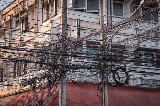 Messy electric cables on poles in Chiang Mai, Thailand