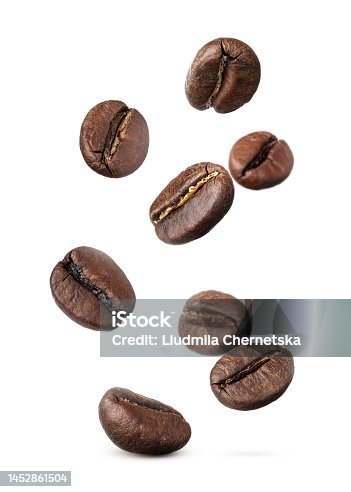 istock Many roasted coffee beans flying on white background 1452861504