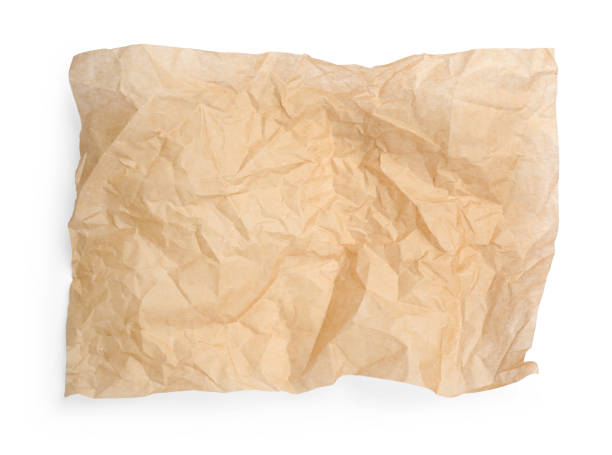 istock Sheet of crumpled brown baking paper on white background, top view 1452861630