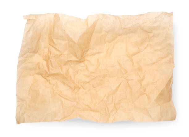 istock Sheet of crumpled brown baking paper on white background, top view 1452861655