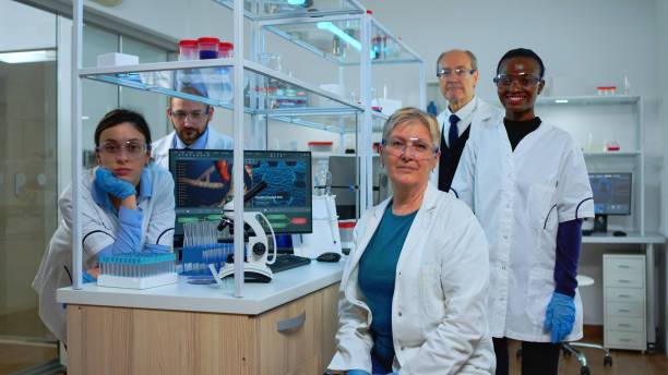 istock Team of multiethnic scientists sitting in laboratory looking at camera 1452861681