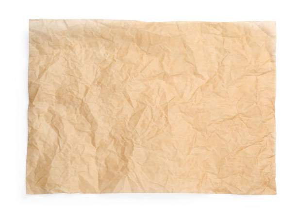 istock Sheet of crumpled brown baking paper on white background, top view 1452861758