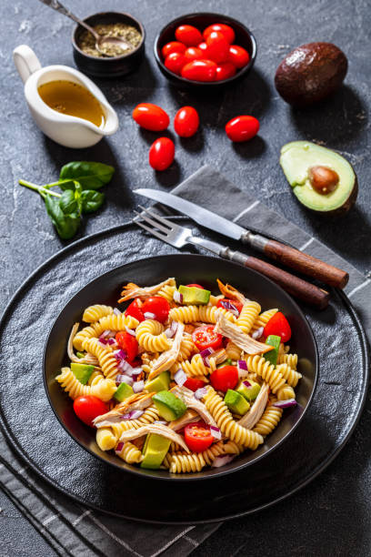 istock Chicken Pasta Salad with Avocado, Tomato in bowl 1452863654