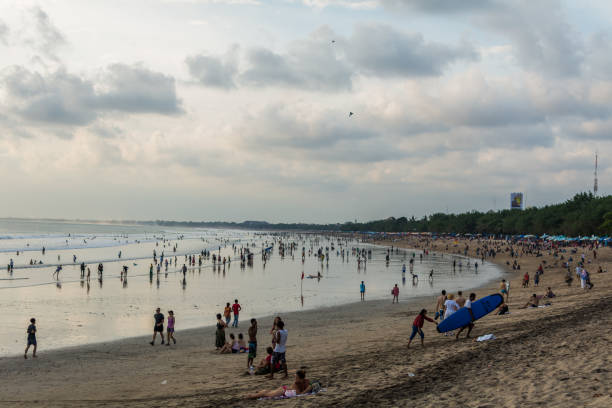 Kuta beach at sunset with clouds and sun