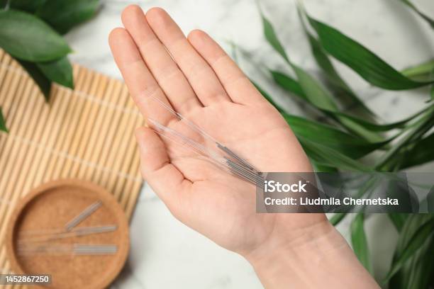 Woman Holding Many Acupuncture Needles Over Table Top View Stock Photo - Download Image Now