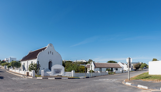 Arniston, South Africa - Sep 22, 2022: A street scene, with the thatched roof Munis Church, in Arniston in the Western Cape Province