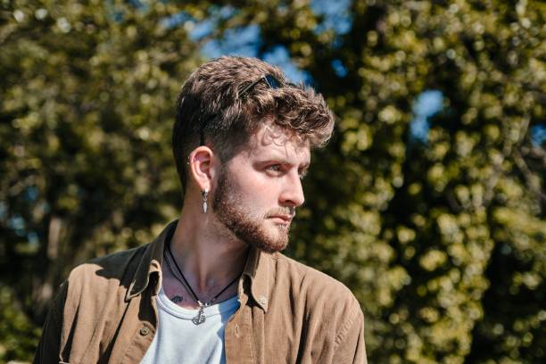 istock Caucasian man in a park looking to the left against blurred background 1452867892