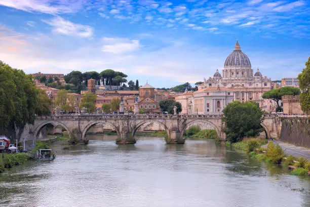 Photo of Tiber River in Rome, Italy: view of  bridge Ponte Sant'Angelo; on background Saint Peter's Basilica.