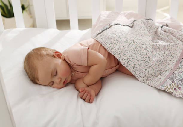 istock Cute little baby sleeping in soft crib at home 1452870676