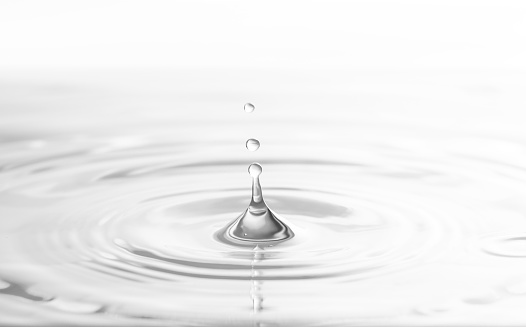 close up of water droplet on blue background