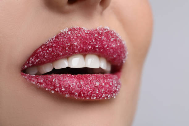istock Young woman with beautiful lips covered in sugar on light background, closeup 1452871878